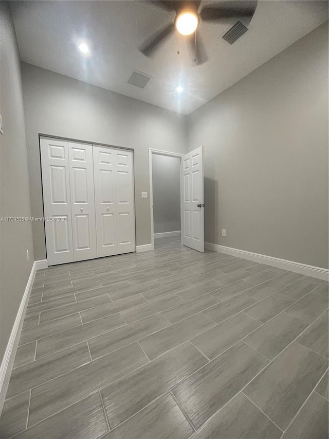 unfurnished bedroom with ceiling fan and a closet