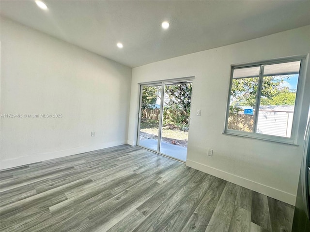 unfurnished room with plenty of natural light and light hardwood / wood-style flooring