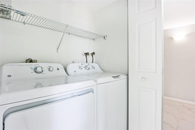 washroom featuring washing machine and clothes dryer