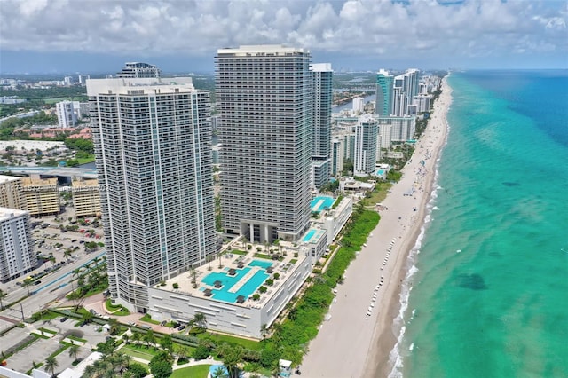 drone / aerial view with a water view and a beach view