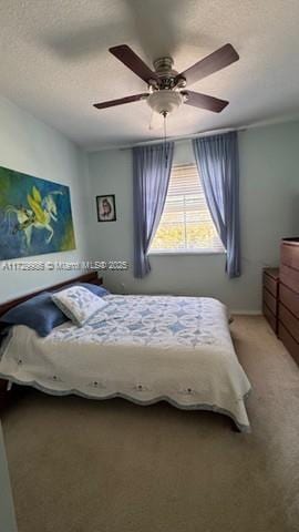 bedroom with ceiling fan and a textured ceiling