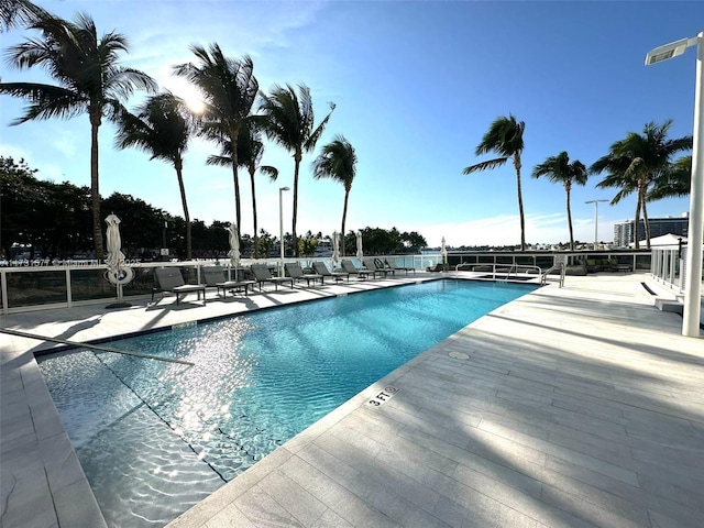 community pool featuring a patio area and fence