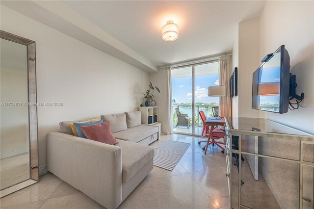 interior space featuring a wealth of natural light, light tile patterned flooring, and a water view