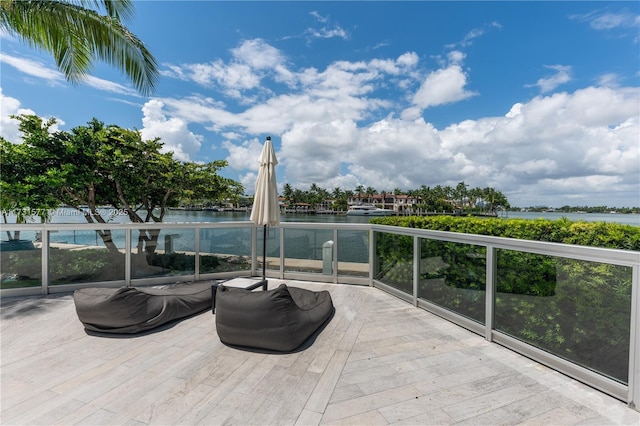 view of patio / terrace featuring a water view and a balcony