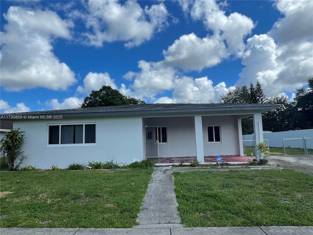 view of front facade with a front yard and a porch