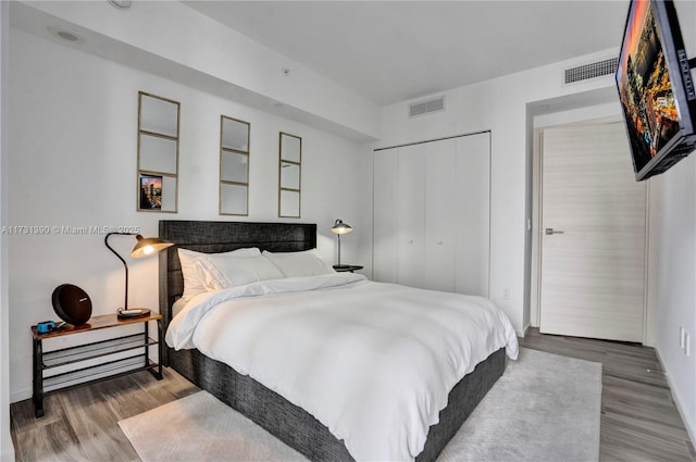 bedroom featuring hardwood / wood-style flooring and a closet