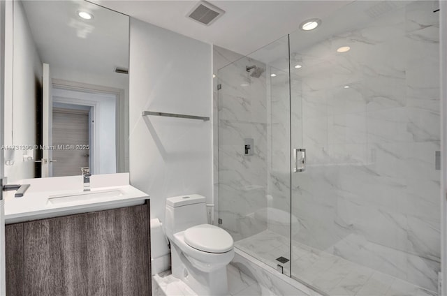 bathroom featuring vanity, an enclosed shower, and toilet