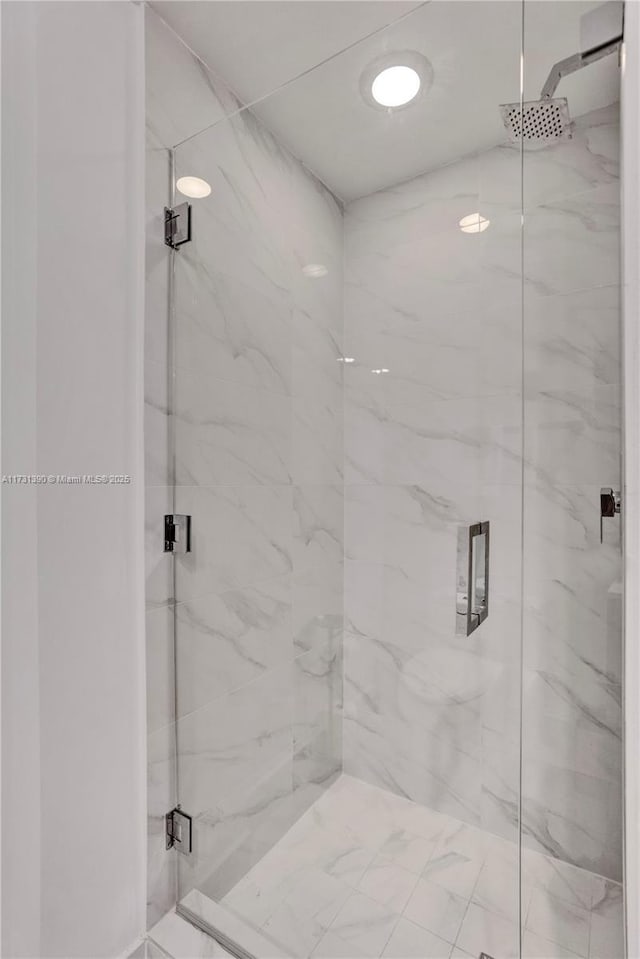 bathroom with a shower with door