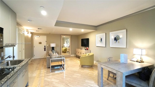 interior space featuring ornamental molding and sink