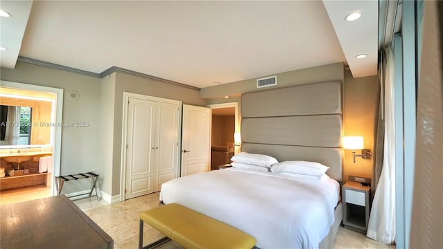 bedroom featuring ornamental molding, a closet, and light tile patterned floors