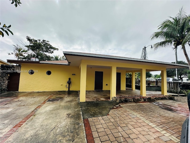 exterior space with fence and stucco siding