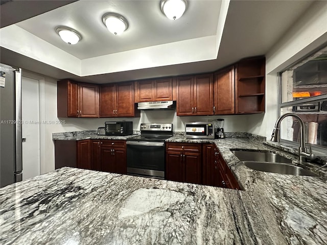 kitchen with open shelves, stainless steel appliances, a raised ceiling, a sink, and under cabinet range hood