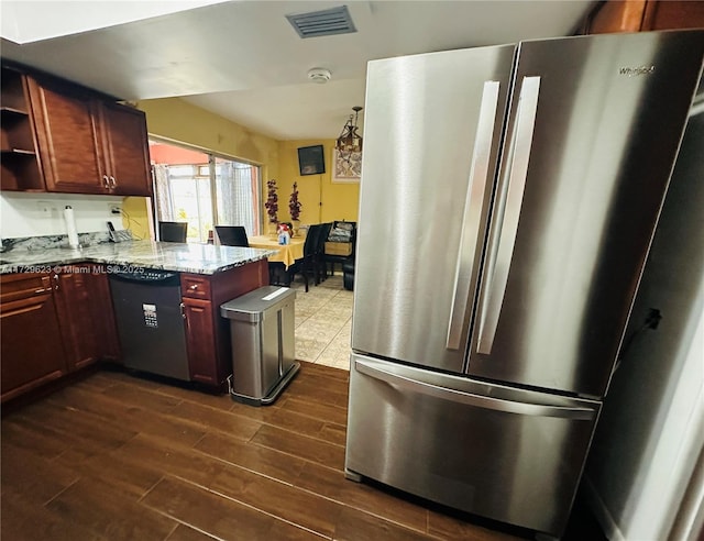 kitchen featuring dishwashing machine, light stone counters, visible vents, freestanding refrigerator, and open shelves