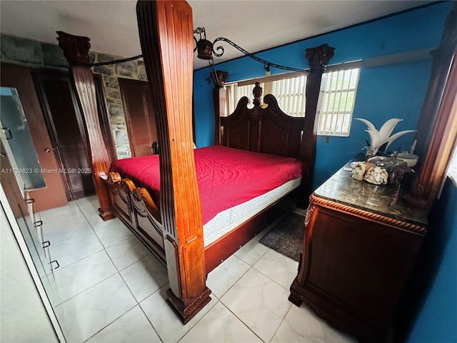 bedroom featuring marble finish floor