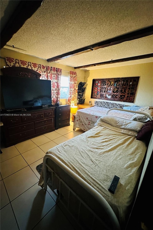 tiled bedroom with a textured ceiling