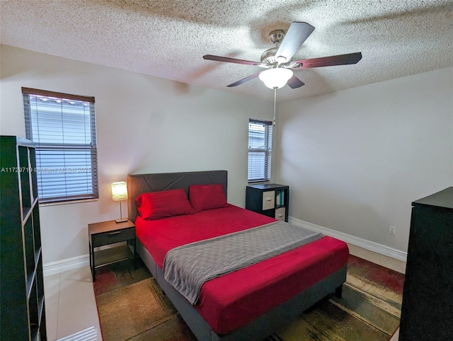 bedroom featuring a textured ceiling and ceiling fan