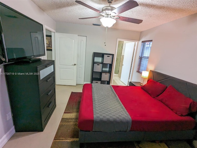 bedroom with a textured ceiling and ceiling fan