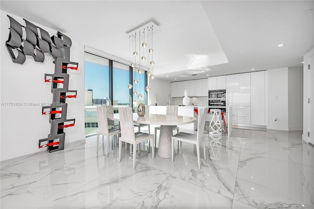 dining area featuring floor to ceiling windows