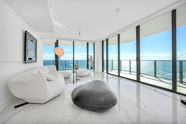 living room with floor to ceiling windows and a water view