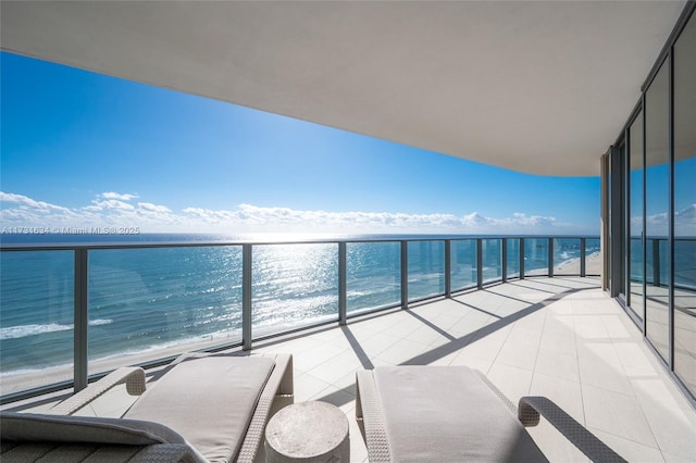 balcony with a view of the beach and a water view