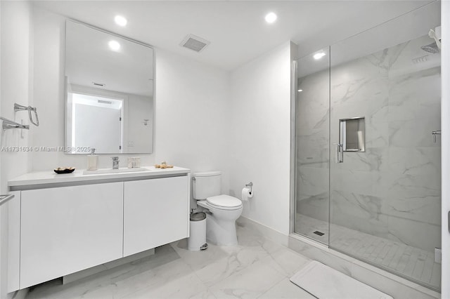 bathroom featuring vanity, toilet, and a shower with shower door