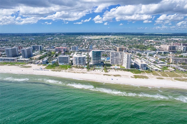 drone / aerial view featuring a water view and a beach view