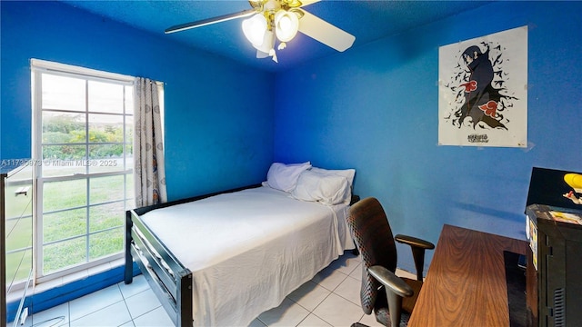 tiled bedroom with multiple windows and ceiling fan