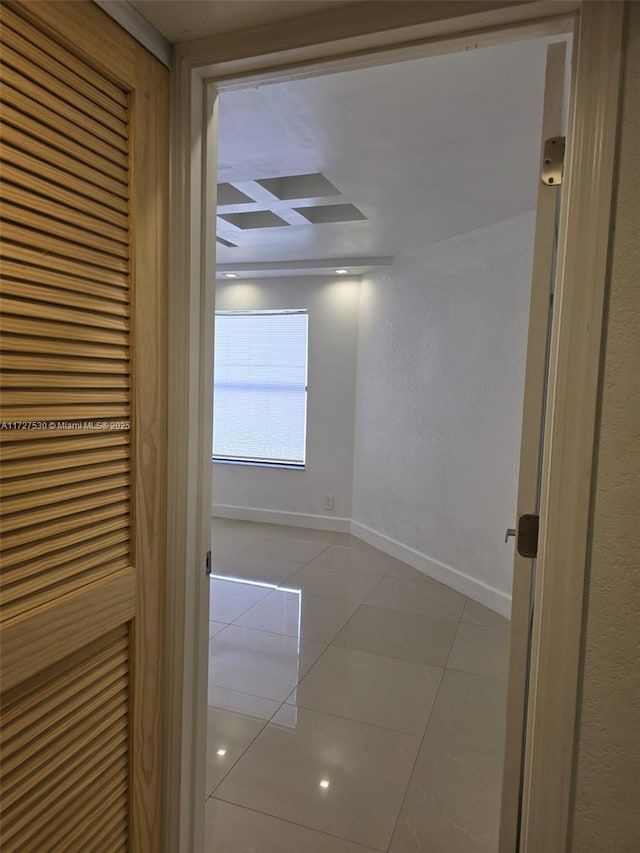 hall featuring light tile patterned flooring