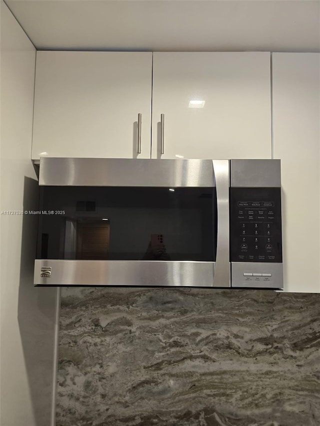 interior details featuring white cabinetry