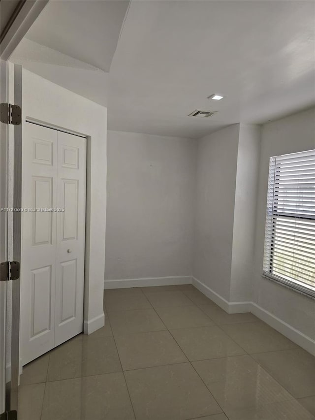 unfurnished room featuring tile patterned floors