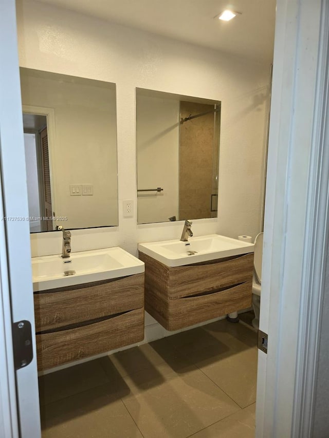 bathroom with vanity, tile patterned floors, and toilet