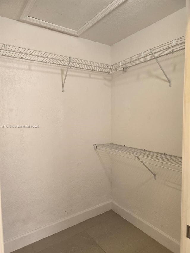 walk in closet featuring tile patterned flooring