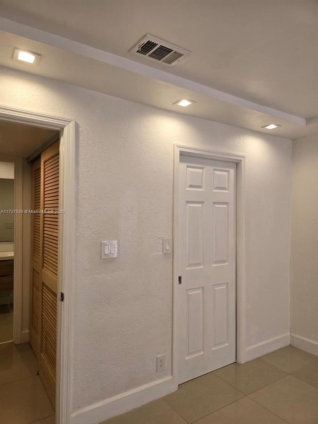 hallway featuring light tile patterned floors