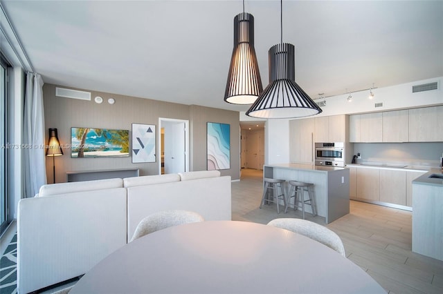 dining space featuring sink and light hardwood / wood-style floors