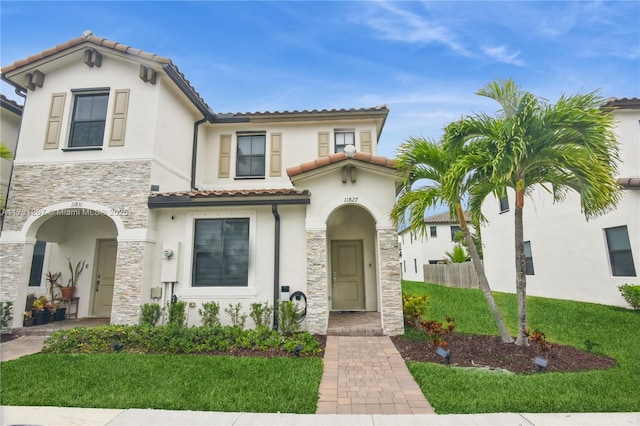 mediterranean / spanish house with a front lawn