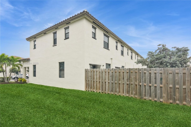 view of side of home featuring a yard