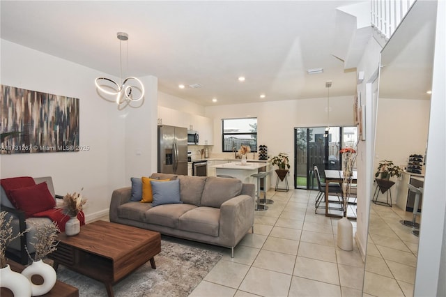 living room featuring light tile patterned flooring and a chandelier