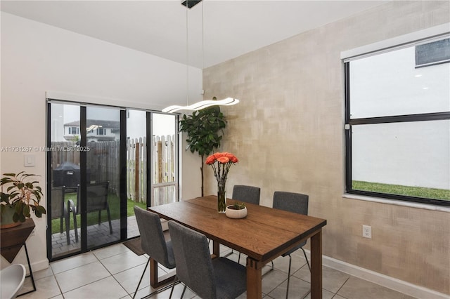 dining space featuring light tile patterned flooring