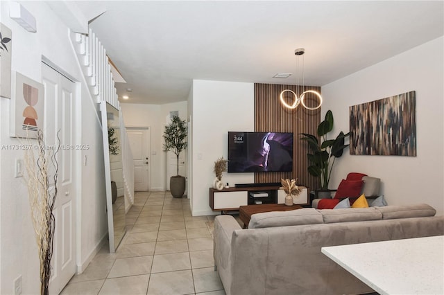 living room with light tile patterned flooring and a notable chandelier