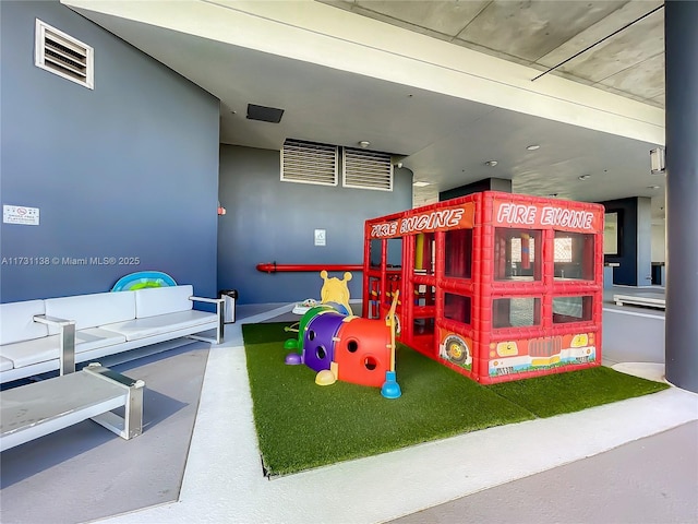 recreation room with concrete flooring