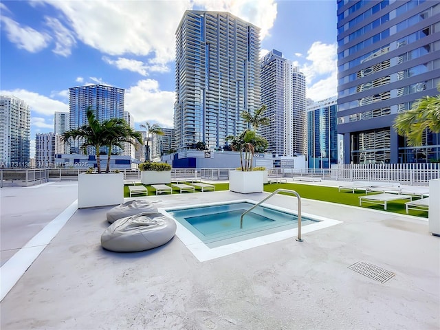 view of pool with a hot tub and a patio