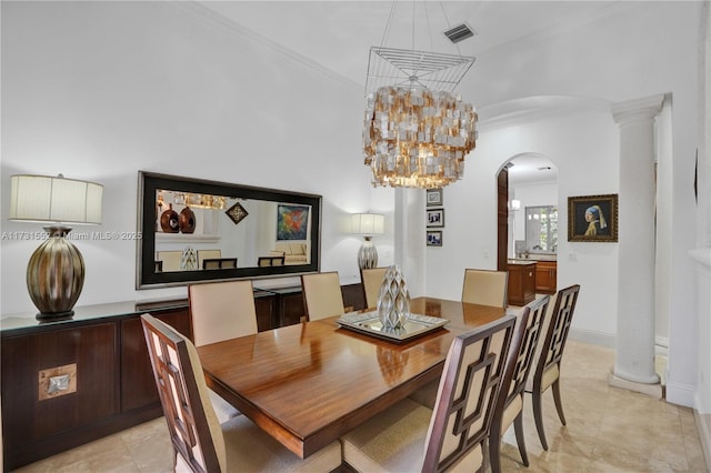 tiled dining room with an inviting chandelier, crown molding, and ornate columns