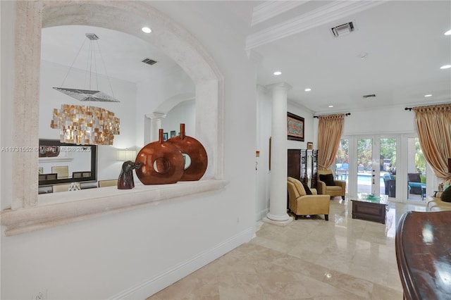 interior space featuring decorative columns, ornamental molding, and french doors