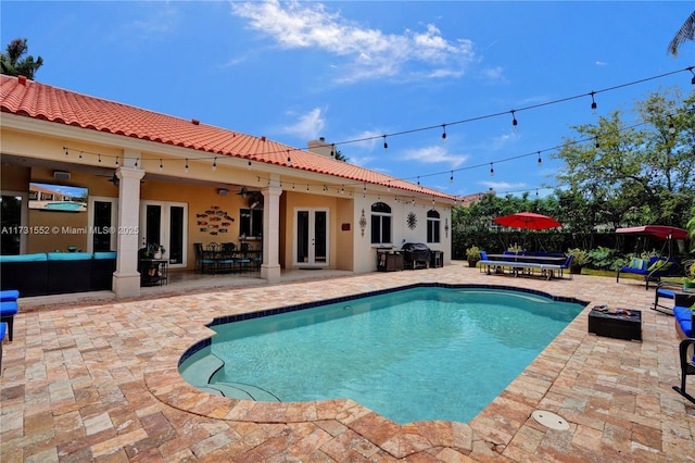 view of pool featuring french doors, a patio area, grilling area, outdoor lounge area, and ceiling fan