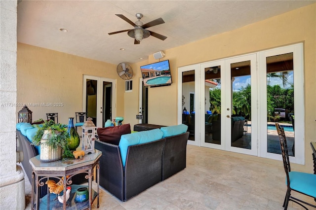 living room with ceiling fan and french doors