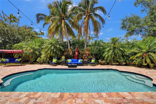 outdoor pool featuring an outdoor living space and a patio