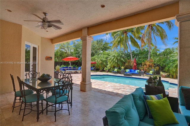 view of swimming pool featuring an outdoor living space, a patio area, and ceiling fan