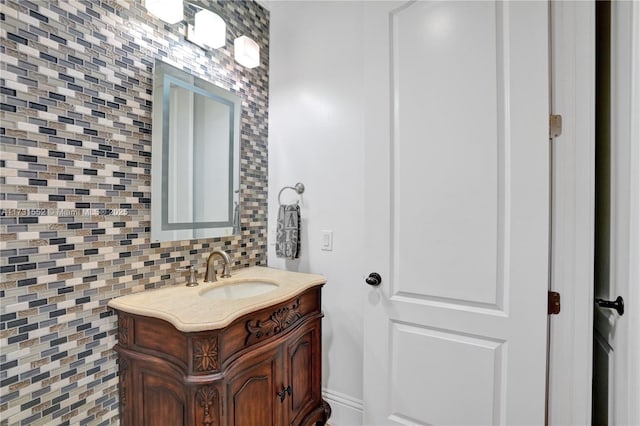 bathroom with vanity and tasteful backsplash