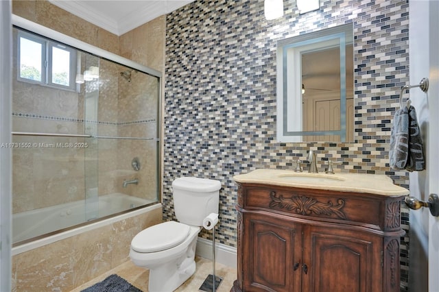 full bathroom featuring toilet, combined bath / shower with glass door, crown molding, tile walls, and vanity