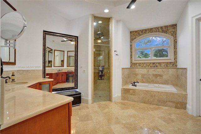 bathroom with plus walk in shower, vanity, and ceiling fan